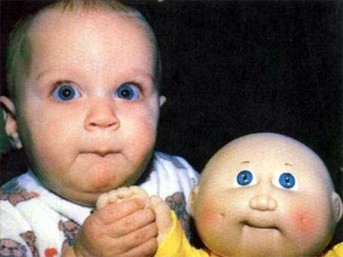 baby-looking-like-his-doll